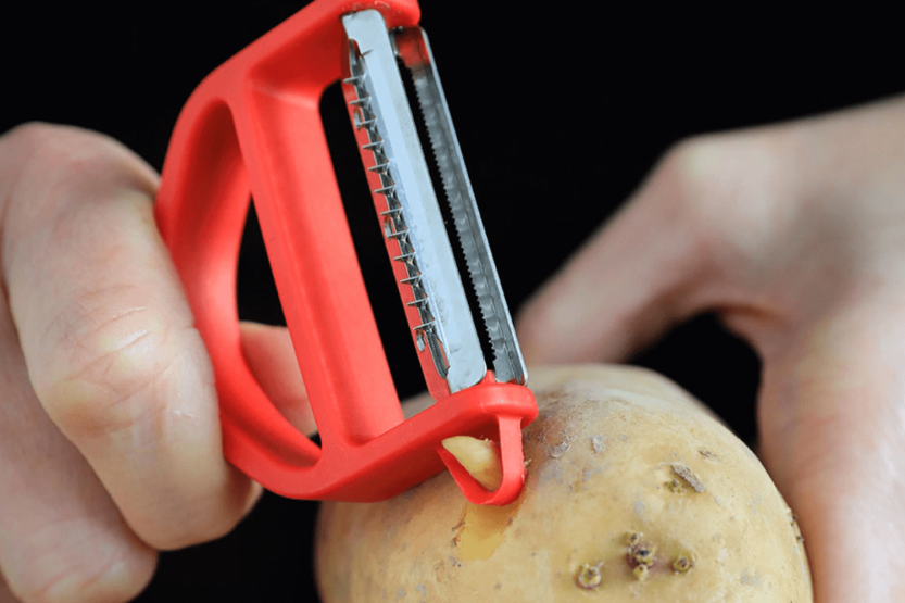 Opinel T-Duo red peeler with double micro-serrated and julienne blades, beechwood handle