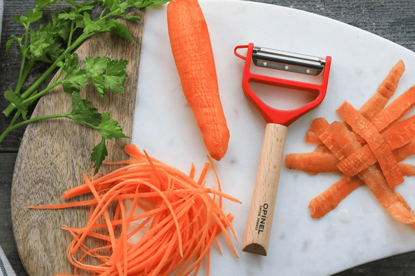 Opinel T-Duo red peeler with double micro-serrated and julienne blades, beechwood handle